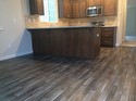 Wood floor in dining and new stainless fridge